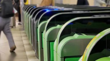 Close up view of the ticket gate in the train station with many passenger get through the ticket gate in rush hour with RFID card in metropolitant big city of Tokyo
