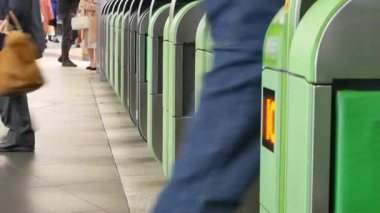 Close up view of the ticket gate in the train station with many passenger get through the ticket gate in rush hour with RFID card in metropolitant big city of Tokyo