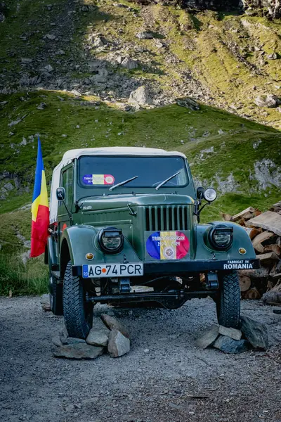 stock image Transagarasan, Romania - 08 02 2024 Old off road military vehicle used to build iconic road in Romania over Carpathian mountains before 50 years