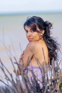 Üstsüz bir Latin model, Sinanche Yucatan Meksika yakınlarındaki bir plajda havanın tadını çıkarıyor.