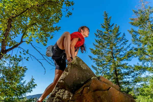 stock image A gorgeous mixed race brunette fitness model climbs rocks in the early afternoon in the Pacific Northwest, U.S.A.