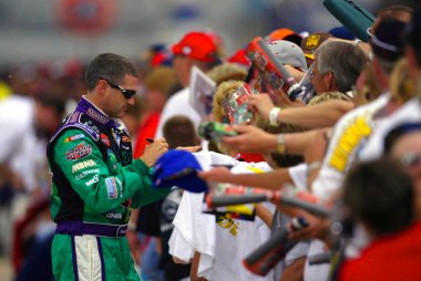 Bobby Labonte takes time out to sign autographs before qualifying for the Sirius 400 NASCAR Winston Cup race at the Michigan International Speedway in Brooklyn, Michigan.  Bobby went on to win the pole for the race. clipart