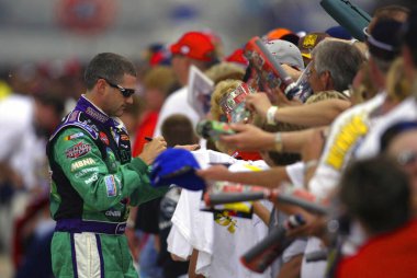 Bobby Labonte takes time out to sign autographs before qualifying for the Sirius 400 NASCAR Winston Cup race at the Michigan International Speedway in Brooklyn, Michigan.  Bobby went on to win the pole for the race.
