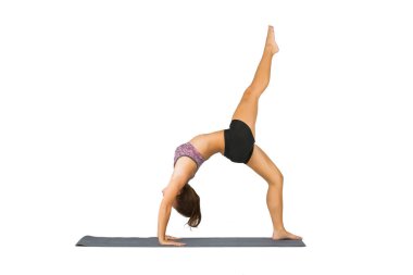 An attractive brunette model poses in a studio environment while exercising