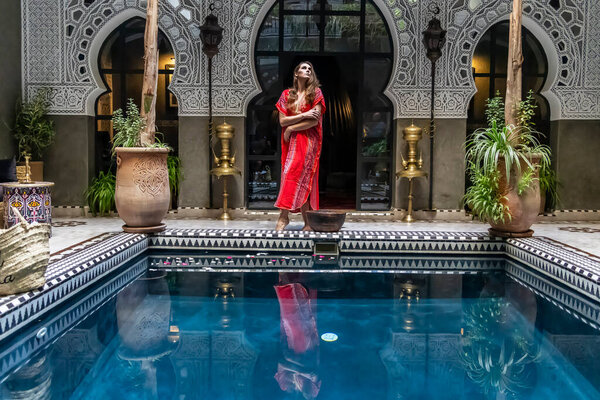 A gorgeous model poses inside a home environment in Medina, Morocco, Africa
