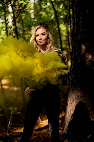 stock image A gorgeous blonde model poses outdoors in a moody forrest environment