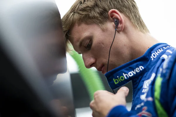 stock image STING RAY ROBB (R) (51) of Payette, Idaho  suits up on pit road prior to a practice for the GMR Grand Prix at Indianapolis Motor Speedway in Speedway IN.