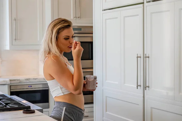 Beautiful Young Blonde Female Enjoys Snack White Kitchen Home — Stock Photo, Image