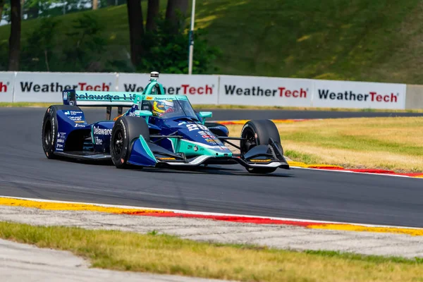 stock image ROMAIN GROSJEAN (28) of Geneva, Switzerland travels through the turns during a practice for the Sonsio Grand Prix at Road America in Elkhart Lake WI.