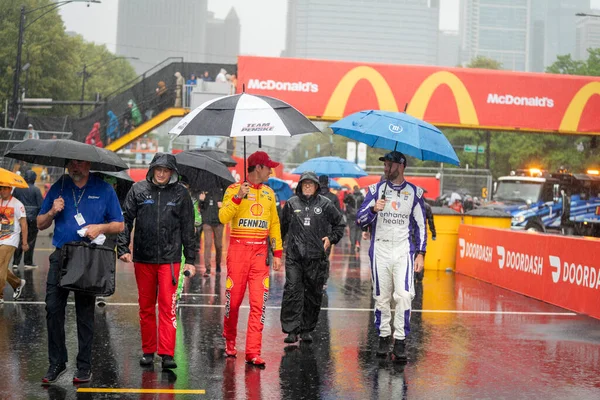 stock image NASCAR Cup Driver, JOEY LOGANO (22) and SHANE VAN GISBERGEN (91) escapes the rain for the Inaugural Grant Park 220 on the Chicago Street Course in Chicago IL.