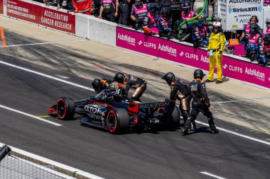 INDYCAR Serisi sürücüsü, SANTINO FERRUCCI (14), Indianapolis Motor Speedwa 'daki Gallagher Grand Prix sırasında lastiği sağ ön tekerden çıkarmak için çalışırken arabasını durdurur.