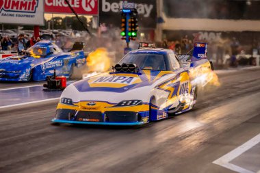 Sep 22, 2023-Concord, NC:  NHRA Funny Car Series driver, Ron Capps, runs down the lane during a qualifying session for the Betway Carolina Nationals. clipart