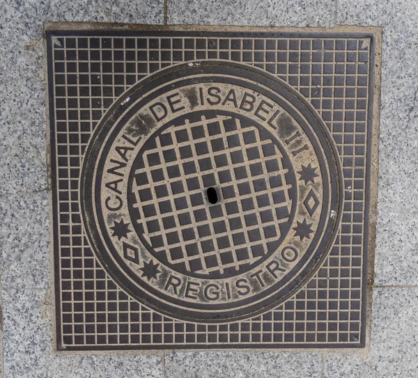 stock image Madrid manhole cover on a busy street in Madrid, Spain