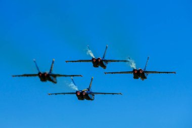 March 01, 2024-El Centro, CA:  Blue Angels rehearse precision aerobatics before season debut, showcasing skill and teamwork in high-flying maneuvers. clipart