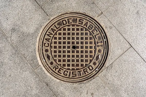 stock image Madrid's cityscape enriched by artistically crafted manhole covers, weaving culture into urban fabric, a testament to city's vibrant identity