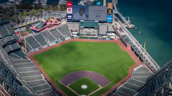 stock image The San Francisco Giants honor Willie Mays, who recently passed away, with a tribute on the centerfield Jumbotron at Oracle Park. The aerial view captures the stadium's beauty against the backdrop of San Francisco Bay.