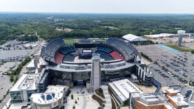 Gillette Stadium, home to the Patriots and Revolution, sprawls in Foxborough, MA, serving sports and events with a capacity of 64,628, opened in 2002 clipart