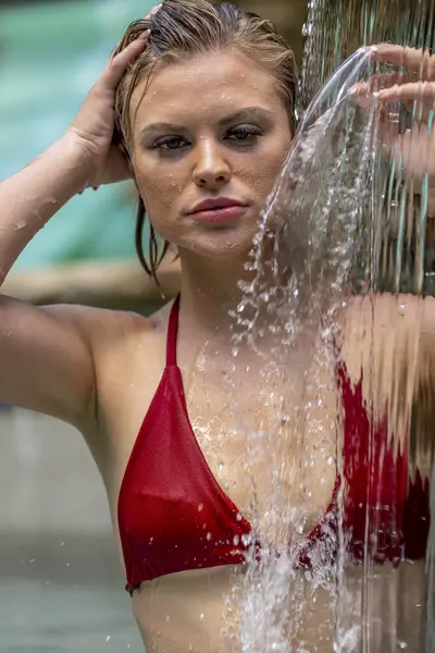 A gorgeous blonde bikini model enjoys a day at home in her swimming pool