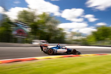 LINUS LUNDQVIST (R) (8) of Stockholm, Sweden drives on track during a practice session for the XPEL Grand Prix at the Road America in Elkhart Lake WI. clipart