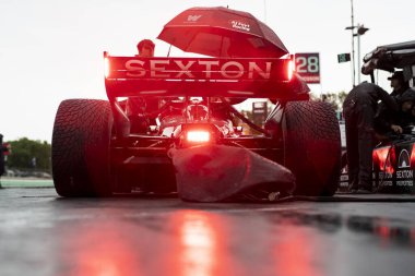 SANTINO FERRUCCI (14) of Woodbury, Connecticut sits in their car on pit road prior to a practice session for the XPEL Grand Prix at the Road America in Elkhart Lake WI. clipart