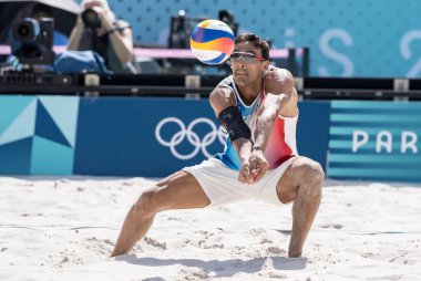 United States Defender MILES EVANS (USA) (1) dives for the ball during their Preliminary Phase - Pool F Mens Beach Volleyball match against France (FRA) at the Stade Tour Eiffel stadium during the 2024 Paris Summer Olympics in Paris, France. clipart