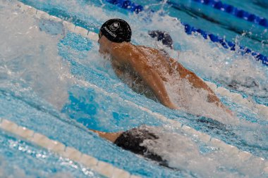 Ilya Kharun (CAN) of Canada, swims in the Men's 200m Butterfly at the Paris La Defense Arena during the 2024 Paris Summer Olympics in Paris, France. clipart