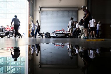 The crew of WILL POWER (12) of Toowoomba, Australia tow the car to pit road prior to qualifying for the Ontario Honda Dealers Indy Toronto at the Streets of Toronto in Toronto ON. clipart