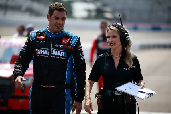 stock image Aug 10, 2024-Richmond , VA;  Stewart Friesen walks by his car before qualifying for the Clean Harbors 250 in Richmond , VA, USA