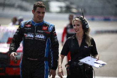 Stewart Friesen walks by his car before qualifying for the Clean Harbors 250 in Richmond , VA, USA clipart