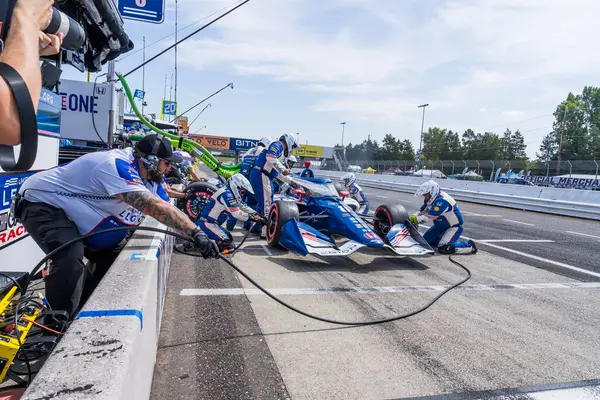 stock image LINUS LUNDQVIST (R) (8) (SWE) of Stockholm, Sweden comes down pit road for service during the Bitnile.com Grand Prix of Portland at Portland International Raceway in Portland, OR.