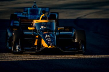 As the sun starts to set, NTT INDYCAR SERIES driver, SANTINO FERRUCCI (14) (USA) of Woodbury, Connecticut races through the turns during the Hy-Vee Milwaukee Mile 250's at The Milwaukee Mile in West Allis, WI. clipart