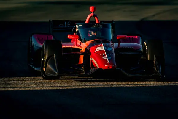 stock image As the sun starts to set, NTT INDYCAR SERIES driver, KATHERINE LEGGE (51) (ENG) of Guildford, England races through the turns during the Hy-Vee Milwaukee Mile 250's at The Milwaukee Mile in West Allis, WI.