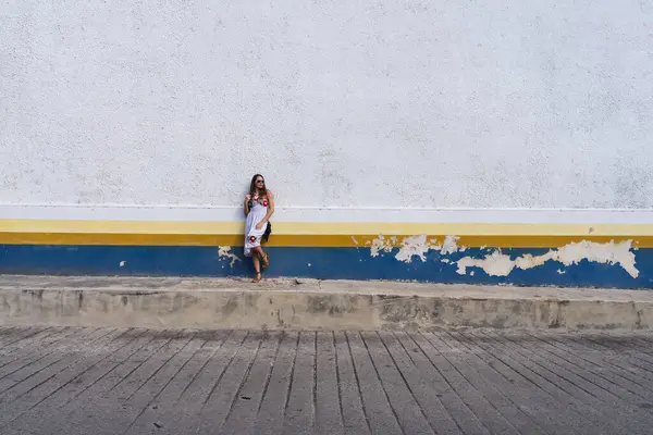 stock image A stunning young traveler explores Telchec, Mexico's vibrant streets, basking in colorful architecture and breathtaking scenery, capturing memorable poses.