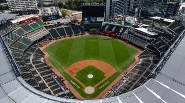 An aerial view of Truist Park showcases a modern baseball stadium nestled in the suburban landscape of Cobb County. Surrounded by The Battery Atlanta, green spaces, and highways, the park blends seamlessly into the bustling Cumberland community, with clipart