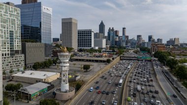 Aerial views of Atlanta showcase a vibrant cityscape with sleek skyscrapers, lush green spaces, and iconic landmarks like Mercedes-Benz Stadium. Highways, railroads, and hills weave through this bustling metropolis. clipart