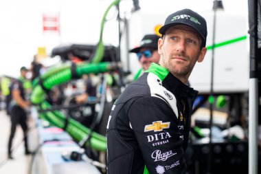 ROMAIN GROSJEAN (77) (SWE) of Geneva, Switzerland talks on pit road prior to a practice session for the HyVee Milwaukee Mile 250s at the Milwaukee Mile in West Allis  WI. clipart