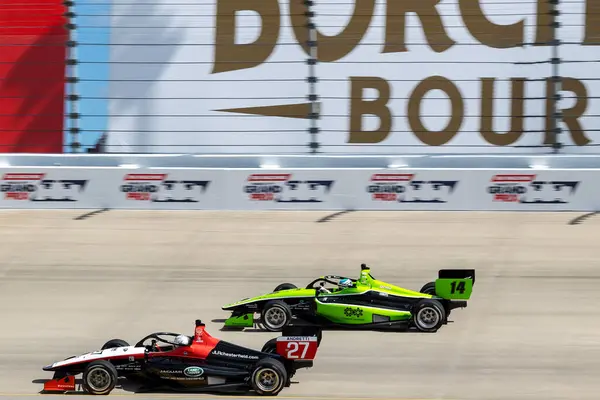 stock image INDY NXT by Firestone Series driver, BRYCE AARON (27) (R) of Winnetka, Illinois races through the turns during the Big Machine Music City Grand Prix Presented by Gainbridge at Nashville Superspeedway in Lebanon, TN.