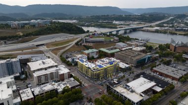 An aerial view of Chattanooga showcases the city's location along the Tennessee River, nestled between mountains and ridges. Known as the 