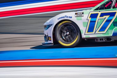 NASCAR Cup Series  driver, CHRIS BUESCHER (17), races through the turns during a practice session for the Bank of America ROVAL 400 at Charlotte Motor Speedway Road Course in Concord, NC. clipart