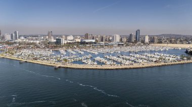 Long Beach 'in havadan görünüşü yoğun bir limanı, ikonik Kraliçe Mary' si, manzaralı deniz manzarası ve genişleyen kentsel manzarası olan canlı bir kıyı şehrini gözler önüne seriyor..