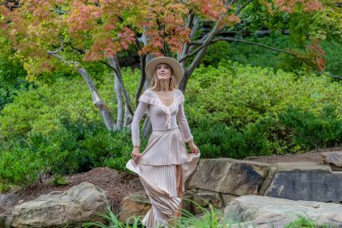 Çarpıcı bir manken defilesi doğanın güzelliği arasına düşer. Pahalı bir park gezisinde zarafet ve cazibe yayar..