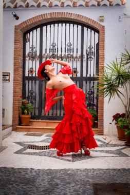 Büyüleyici üstsüz İspanyol modeli, Frigiliana sokaklarında geleneksel kıyafetlerini sergiliyor..