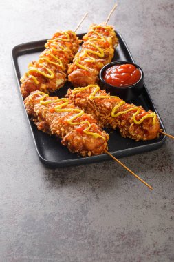 Kore Corndog 'u Kore sokak yemeği mozzarella peyniri ve sosisli sandviçten oluşuyor. Sonra da masaya yakın tabakta dövülmüş ve kızartılmış altın kahverengiye dönmüştü. Dikey