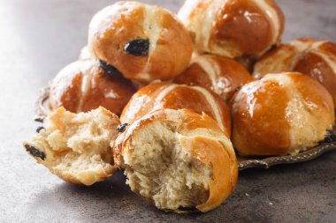 Homemade Hot Cross Buns Ready for Easter closeup on the plate on the table. Horizonta