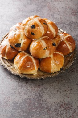 Easter Breakfast with Hot Cross Buns closeup on the plate on the table. Vertica