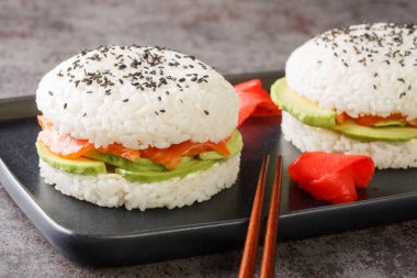 Delicious and exquisite sushi burger with vegetables and salmon fish as Japanese appetizers close-up. Horizonta