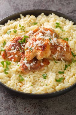 Chicken with Garlic Parmesan Rice closeup on the plate on the table. Vertica