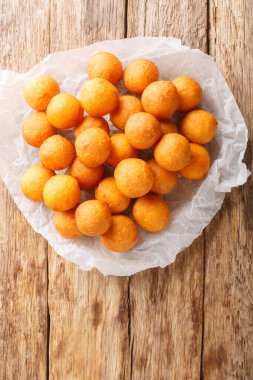 Khanom khai nok kratha Thai Derin Kızarmış Tatlı Patates Topları ahşap masaya yakın çekim. Yukarıdan dikey üst görünüm