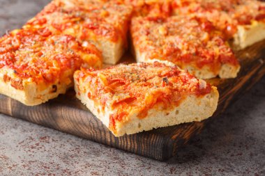 Soğan, domates sosu, ançüez, caciocavallo peyniri ve ekmek kırıntılarıyla hazırlanmış Sicilyalı sfincione italyan pizza Focaccia ekmeği masanın üzerindeki ahşap tahtaya yakın plan. Yatay