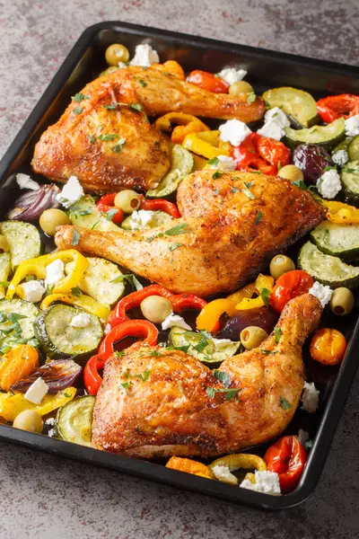 Greek Sheet Pan Chicken With Vegetables and Feta closeup on the table. Vertica